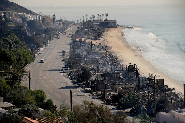 Beach front properties are left smoldering in the aftermath of the Palisades Fire Friday, Jan. 10, 2025 in Malibu, Calif. (AP Photo/John Locher)