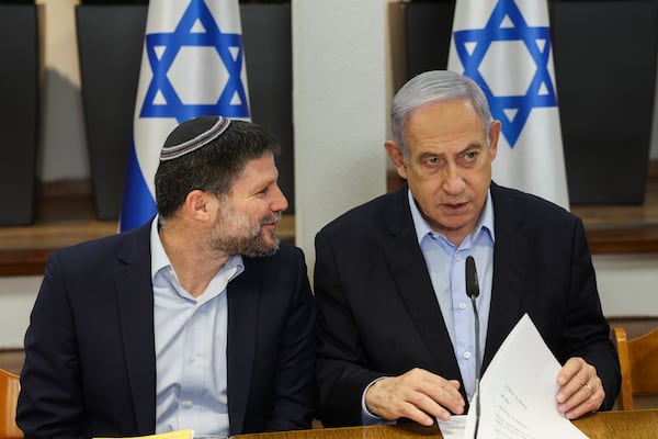 FILE - Israeli Prime Minister Benjamin Netanyahu, right, speaks with Minister of Finance Bezalel Smotrich during the weekly cabinet meeting at the Defence Ministry in Tel Aviv, Israel, Jan. 7, 2024. (Ronen Zvulun/Pool via AP, File)