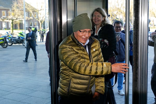 Peruvian farmer Luciano Lliuya arrives with lawyer Roda Verheyen at the Higher Regional Court in Hamm, Germany, for a first hearing of his climate damages case against the German energy company RWE for its carbon emissions, which may have been contributing to the melting of a nearby glacier that could flood his home, Monday, March 17, 2025. (AP Photo/Martin Meissner)