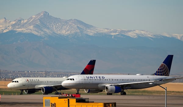 United and Delta Airlines jetliners taxi down a runway for take off at Denver International Airport, Tuesday, Dec. 24, 2024, in Denver. (AP Photo/David Zalubowski)