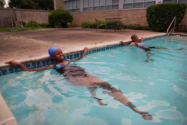 Sister Seyram Mary Adzokpa and Sister Clara Mae Jackson, of the Sisters of the Holy Family, swim in the pool at the motherhouse in New Orleans, Tuesday, June 25, 2024. (AP Photo/Jessie Wardarski)