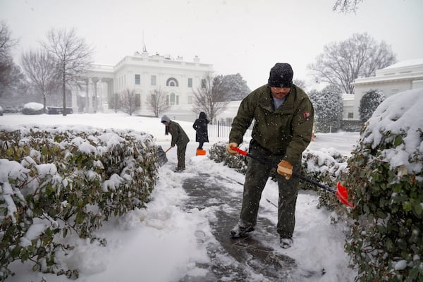 National Park Service workers shovel a pathway during a winter storm at the White House, Monday, Jan. 6, 2025, in Washington. (AP Photo/Mark Schiefelbein)