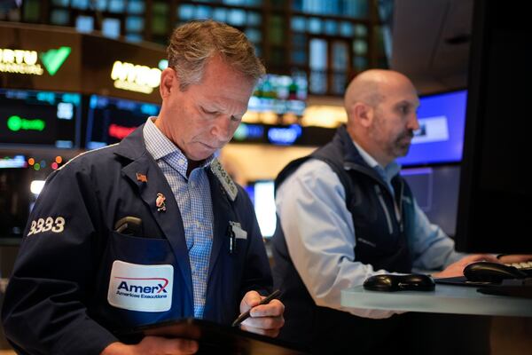 Traders work on the floor at the New York Stock Exchange in New York's Financial District Thursday, Jan. 2, 2025. (AP Photo/Seth Wenig)