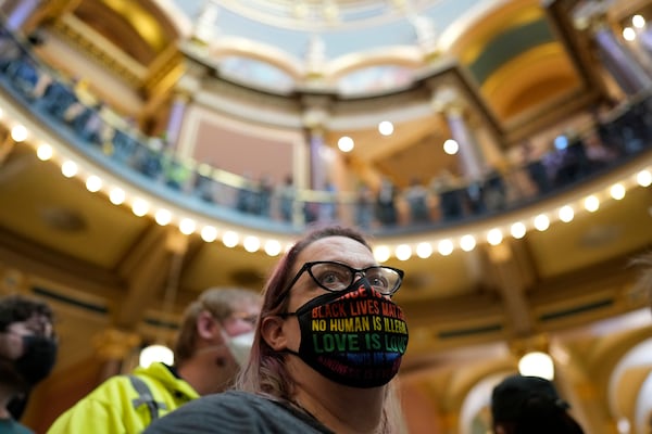 Protesters fill the Iowa state Capitol to denounce a bill that would strip the state civil rights code of protections based on gender identity, Thursday, Feb. 27, 2025, in Des Moines, Iowa. (AP Photo/Charlie Neibergall)