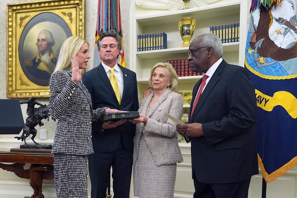 Pam Bondi is sworn in as Attorney General by Supreme Court Associate Justice Clarence Thomas, right, as partner John Wakefield and mother Patsy Bondi, look on, in the Oval Office of the White House, Wednesday, Feb. 5, 2025, in Washington. (AP Photo/Evan Vucci)