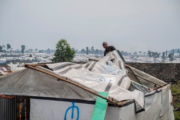 A man displaced by the fighting between M23 rebels and government soldiers prepares to leave the camp following an instruction by M23 rebels in Goma, Democratic Republic of the Congo, Tuesday, Feb. 11, 2025. (AP Photo/Moses Sawasawa)