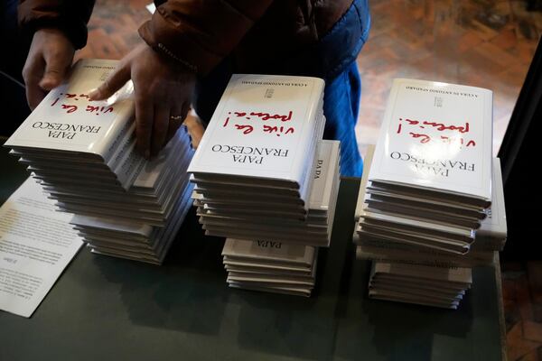 Copies of the book by Pope Francis titled "Viva la Poesia" (long live poetry) are set on a desk during its presentation to the journalists in Rome, Friday, March 21, 2025. (AP Photo/Gregorio Borgia)