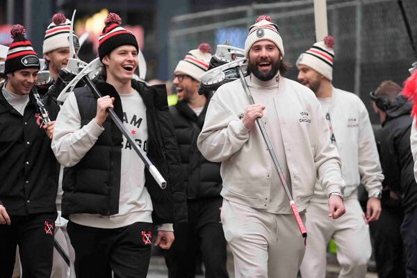 Chicago Blackhawks left wing Lukas Reichel, left, and left wing Patrick Maroon arrive with the team for the NHL Winter Classic outdoor hockey game featuring the Blackhawks and St. Louis Blues at Wrigley Field, Tuesday, Dec. 31, 2024, in Chicago. (AP Photo/Erin Hooley)