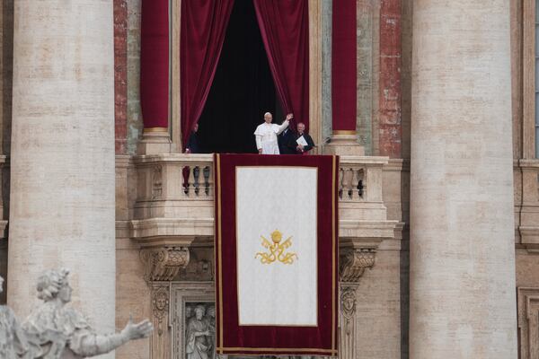Pope Leo XIV appears at the central balcony of St. Peter's Basilica for his first Sunday blessing after his election, in St. Peter¥s Square at the Vatican, Sunday May 11, 2025. (AP Photo/Alessandra Tarantino)