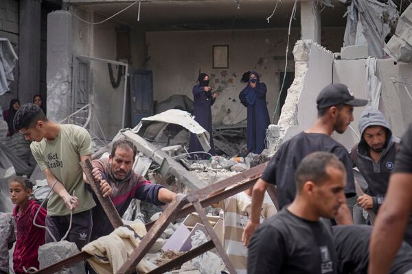 Palestinians search the rubble of a house targeted by an Israeli army strike that killed killing at least five members of the Abu Sahloul family in Khan Younis, in the southern Gaza Strip, Thursday, May 1, 2025. (AP Photo/Abdel Kareem Hana)