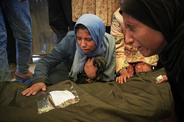 Islam Abu Sahloul mourns the death of her sister Lamia, 32, who was killed when an Israeli army strike hit a house killing at least five members of the Abu Sahloul family, in Khan Younis, in the southern Gaza Strip, Thursday, May 1, 2025. (AP Photo/Abdel Kareem Hana)