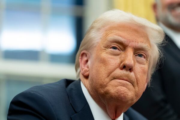 FILE - President Donald Trump speaks with reporters as he signs executive orders in the Oval Office at the White House, Feb. 10, 2025, in Washington. (AP Photo/Alex Brandon, file)