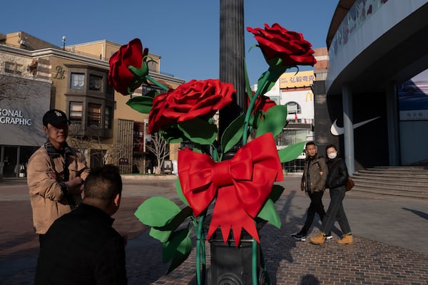 Shoppers pass by a decoration at a mall ahead of the National People's Congress in Beijing, on Feb. 26, 2025. (AP Photo/Ng Han Guan)