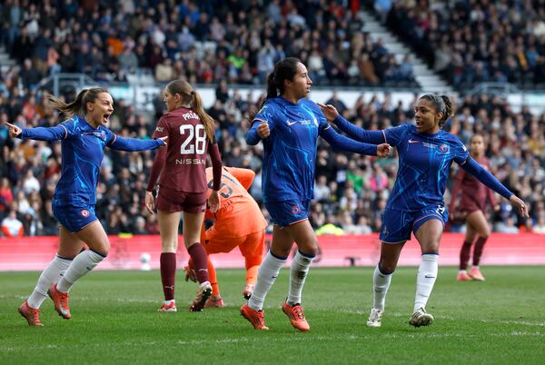 Chelsea's Mayra Ramirez (left) celebrates scoring their side's first goal of the game with team-mate Catarina Macario during the English women's League Cup soccer final match between Chelsea and Manchester City, at Pride Park Stadium, Derby, England, Saturday March 15, 2025. (Richard Sellers/PA via AP)