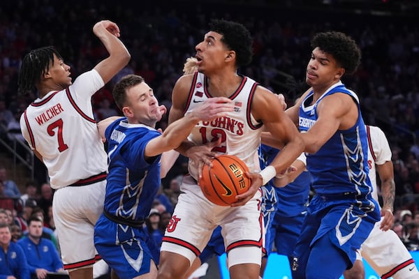 Creighton's Steven Ashworth, second from left, and Jasen Green, right, defend against St. John's's RJ Luis Jr. (12) during the first half of an NCAA college basketball game in the championship of the Big East Conference tournament Saturday, March 15, 2025, in New York. (AP Photo/Frank Franklin II)