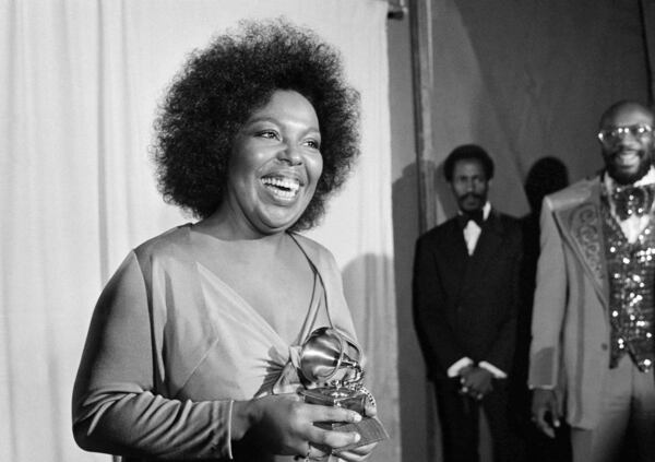 FILE - Roberta Flack holds the Grammy award for her record, "Killing Me Softly With His Song" as singer Isaac Hayes, right, looks on at the Grammy Awards in Los Angeles on March 4, 1974. (AP Photo/Harold Filan, File)