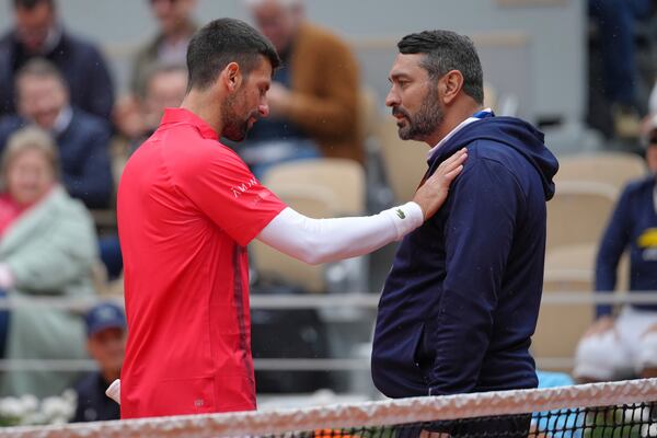 Serbia's Novak Djokovic talks with a judge as he plays Mackenzie McDonald of the U.S. during their first round match of the French Tennis Open, at the Roland-Garros stadium, in Paris, Tuesday, May 27, 2025. (AP Photo/Thibault Camus)