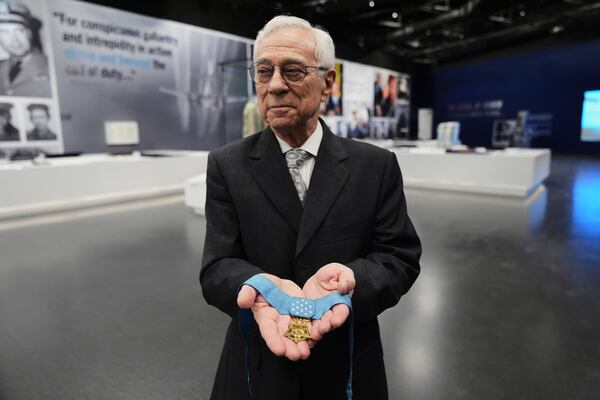 Jack Jacobs, a retired U.S. Army colonel who was awarded the Medal of Honor for his actions during the Vietnam War, poses for a photo holding the medal in his hands while being interviewed at the National Medal of Honor Museum in Arlington, Texas, Thursday, March 13, 2025. (AP Photo/Tony Gutierrez)