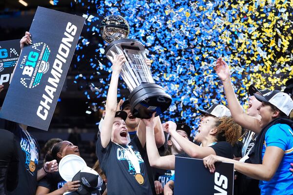 UCLA players celebrate after an NCAA college basketball game against Southern California in the championship of the Big Ten Conference tournament in Indianapolis, Sunday, March 9, 2025. (AP Photo/Michael Conroy)