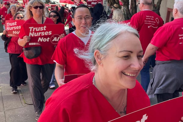 In this photo provided by National Nurses United, Melissa Beebe, foreground, and other nurses hold a rally in San Francisco on April 22, 2024, to highlight safety concerns about using artificial intelligence in health care. (National Nurses United via AP)