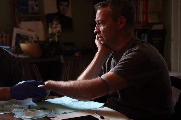 Jake Heinrichs prepares for his infusion treatment with an experimental anti-amyloid Alzheimer's drug while at home in New York, on Wednesday, March 12, 2025. (AP Photo/Heather Khalifa)