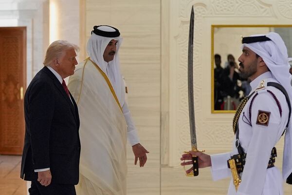 President Donald Trump and Qatar's Emir Sheikh Tamim bin Hamad Al Thani reviews Qatari honor guard during an official welcoming ceremony at the Amiri Diwan in Doha, Qatar, Wednesday, May 14, 2025. (AP Photo/Alex Brandon)