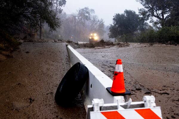 A road is covered in mud in the Eaton Fire zone during a storm Thursday, Feb. 13, 2025, in Altadena, Calif. (AP Photo/Etienne Laurent)