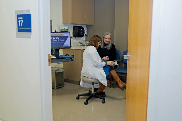 Patient Lory Osborn (right) speaks with Dr. Laura Davisson, director of the Medical Weight Management at West Virginia University in Morgantown, W.Va., Monday, Dec. 2, 2024. (AP Photo/Kathleen Batten)