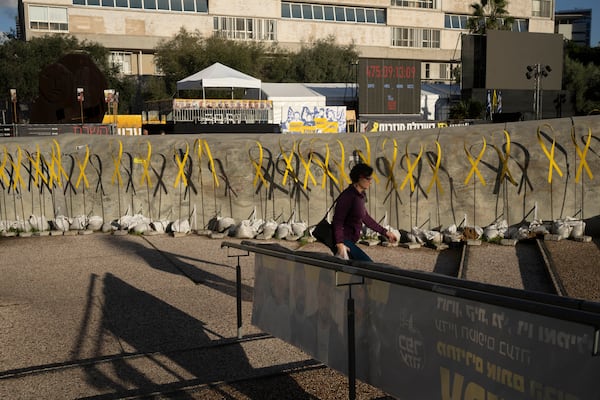 Yellow ribbons for hostages held by the Hamas militant group in the Gaza Strip line a replica of a Gaza tunnel in Tel Aviv, Israel, Friday, Jan. 24, 2025. (AP Photo/Maya Alleruzzo)