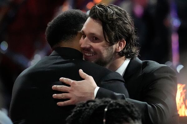 Buffalo Bills' Josh Allen, right, hugs Cleveland Browns' Myles Garrett during the NFL Honors award show ahead of the Super Bowl 59 football game, Thursday, Feb. 6, 2025, in New Orleans. (AP Photo/David J. Phillip)