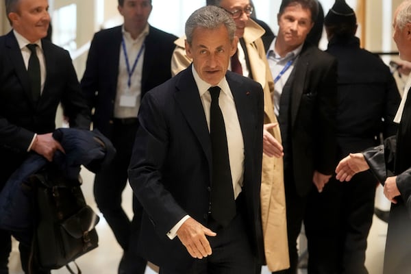 Former French President Nicolas Sarkozy arrives as he goes on trial over alleged illegal financing of his 2007 presidential campaign by the government of late Libyan leader Moammar Gadhafi, Monday, Jan. 6, 2025 in Paris. (AP Photo/Thibault Camus)