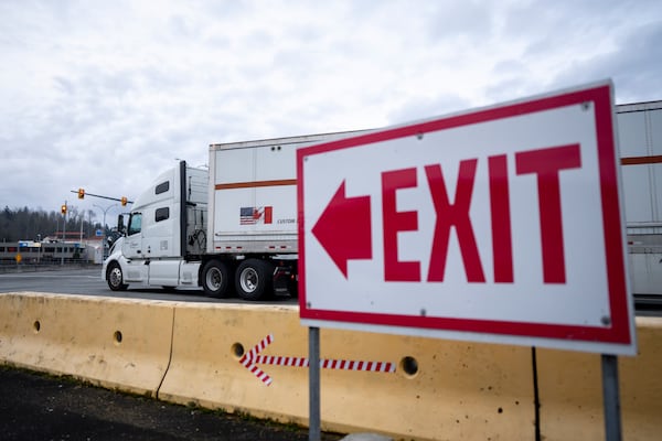 A truck waits to cross at the United States and Canada border in Surrey B.C., on Tuesday, March 4, 2025. (Ethan Cairns /The Canadian Press via AP)