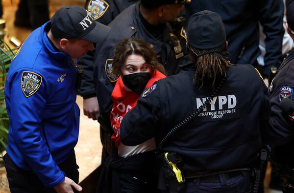 New York Police officers arrest a demonstrator from the group, Jewish Voice for Peace, who protested inside Trump Tower in support of Columbia graduate student Mahmoud Khalil, Thursday, March 13, 2025, in New York. (AP Photo/Yuki Iwamura)