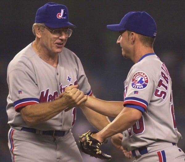 FILE - Montreal Expos manager Jeff Torborg, left, congratulates relief pitcher Scott Strickland after the Expos defeated the New York Yankees 2-1 in 12 innings Tuesday, June 12, 2001, in New York. Strickland was the winning pitcher. (AP Photo/Mark Lennihan, File)