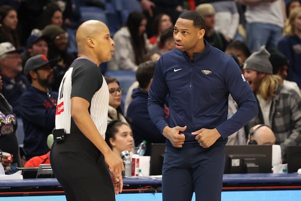 New Orleans Pelicans head coach Willie Green, right, argues a call with a referee in the second half of an NBA basketball game against the Utah Jazz in New Orleans, Monday, Jan. 20, 2025. (AP Photo/Peter Forest)