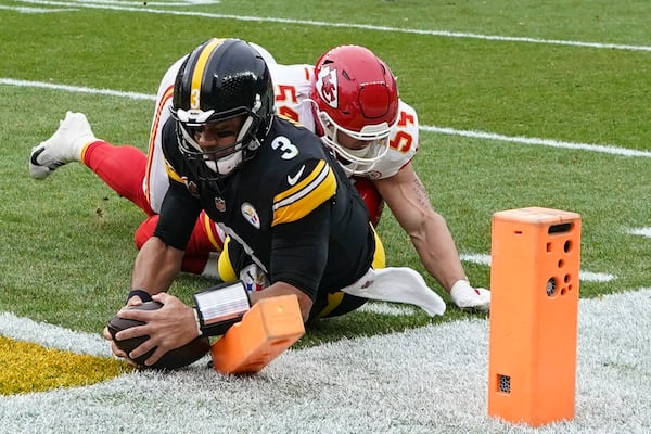 Pittsburgh Steelers quarterback Russell Wilson (3) runs into the end zone for a touchdown against Kansas City Chiefs linebacker Leo Chenal (54) during the first half of an NFL football game, Wednesday, Dec. 25, 2024, in Pittsburgh. (AP Photo/Matt Freed)