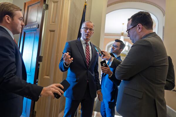 Reporters pose questions to Senate Majority Leader John Thune, R-S.D., as Republicans work to pass an interim spending bill that would avoid a partial government shutdown and keep federal agencies funded through September, at the Capitol in Washington, Tuesday, March 11, 2025. (AP Photo/J. Scott Applewhite)