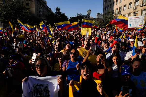 Opponents of Venezuelan President Nicolas Maduro participate in a protest the day before his inauguration for a third term, in Santiago, Chile, Thursday, Jan. 9, 2025. (AP Photo/Esteban Felix)