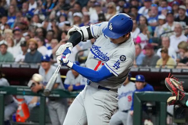 Los Angeles Dodgers' Shohei Ohtani hits a double against the Arizona Diamondbacks during the second inning of a baseball game Friday, May 9, 2025, in Phoenix. (AP Photo/Darryl Webb)
