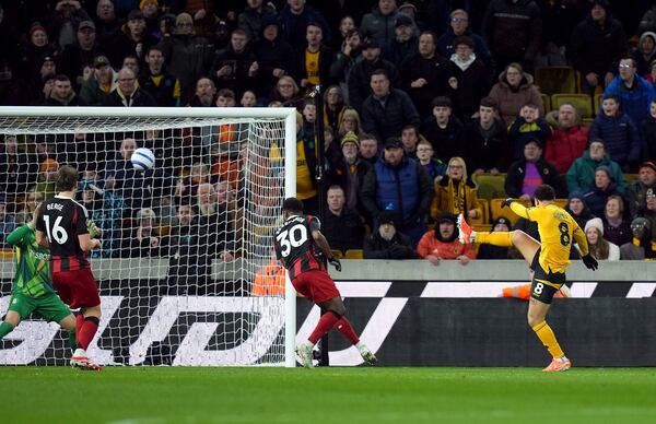 Wolverhampton Wanderers' Joao Gomes, right, scores their side's first goal of the game during the English Premier League soccer match between Wolverhampton Wanderers and Fulham at Molineux Stadium, Wolverhampton, England, Tuesday, Feb. 25, 2025. (Jacob King/PA via AP)