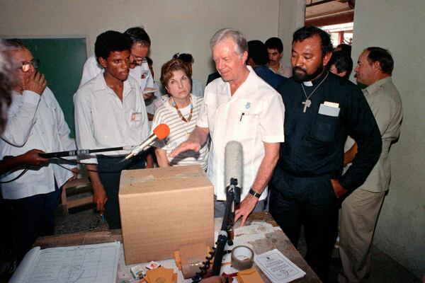 FILE - Former U.S. President Jimmy Carter stands in a polling station at San Miguelito, Panama, as part of an international delegation of observers under the Council of Freely-Elected Heads of Government on May 7, 1989. (AP Photo/Luis Romero, File)