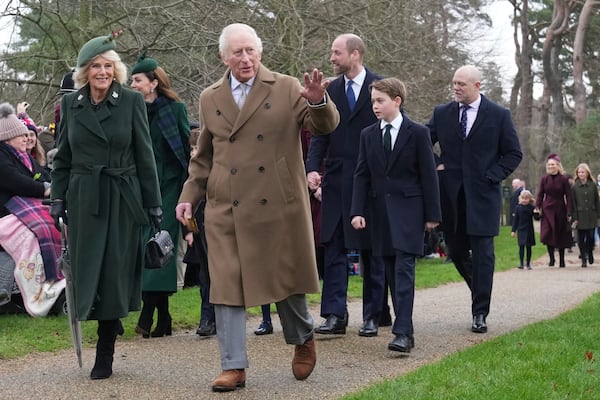 Britain's King Charles III waves to the crowd as he and Queen Camilla, Prince William, Prince George attend the Christmas day service at St Mary Magdalene Church in Sandringham in Norfolk, England, Wednesday, Dec. 25, 2024. (AP Photo/Jon Super)