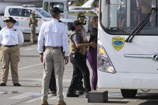 People arrive to board a repatriation flight bound for Colombia at Albrook Airport in Panama City, Monday, Feb. 3, 2025. (AP Photo/Mark Schiefelbein, Pool)