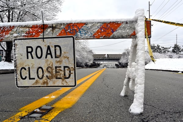 A road is closed due to flooding in Louisville, Ky., Sunday, Feb. 16, 2025. (AP Photo/Timothy D. Easley)