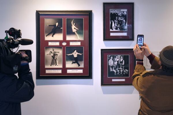 Journalists photograph a memorial to local skaters killed in a 1961 plane crash at The Skating Club of Boston, Thursday, Jan. 30, 2025, in Norwood, Mass. (AP Photo/Charles Krupa)