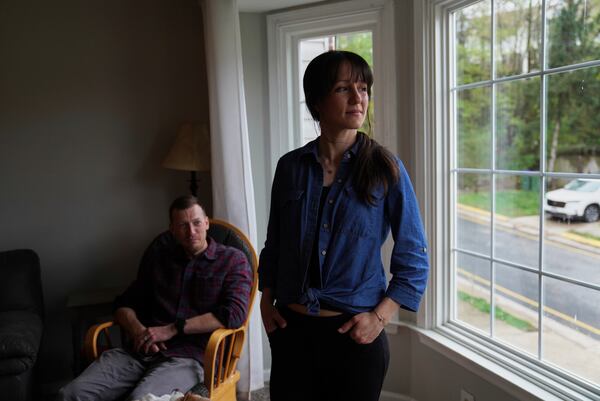 Phil Williams, a former Marine, and his wife Katlyn Williams pose for a portrait at their home in Stafford, Va., on Monday, April 7, 2025. (AP Photo/Jessie Wardarski)