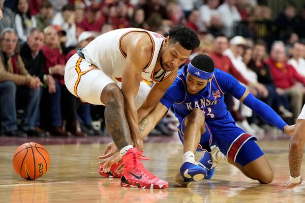 Kansas guard Dajuan Harris Jr. (3) fights for a loose ball with Iowa State forward Joshua Jefferson, left, during the first half of an NCAA college basketball game Wednesday, Jan. 15, 2025, in Ames, Iowa. (AP Photo/Charlie Neibergall)