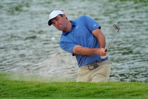 Scottie Scheffler hits out of a bunker on the 18th hole during the first round of the Charles Schwab Challenge golf tournament at Colonial Country Club in Fort Worth, Texas, Thursday, May 22, 2025. (AP Photo/LM Otero)
