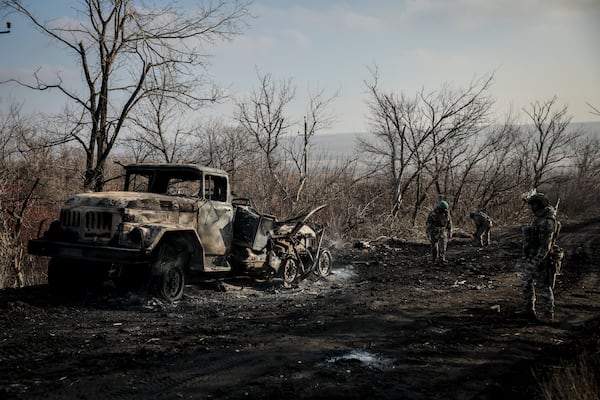 Ukrainian servicemen collect damaged ammunition on the road at the front line near Chasiv Yar town, in Donetsk region, Ukraine, Ukraine, Friday, Jan. 10, 2025. (Oleg Petrasiuk/Ukraine's 24th Mechanised Brigade via AP)