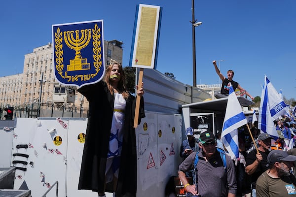 People protest a outside the Knesset, Israel's parliament, in Jerusalem on Sunday, March 23, 2025, as the Israeli cabinet is set to hold a no-confidence vote against Attorney General Gali Baharav-Miara. (AP Photo/Ohad Zwigenberg)